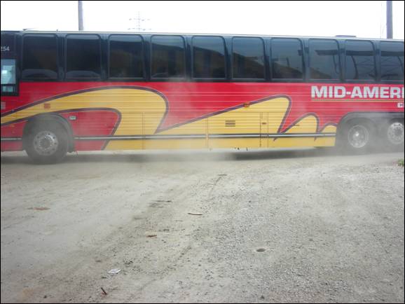 Bus driving up dust at the old station's dirt road